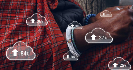 Image of clouds with growing numbers over african american man using smartphone. Global...