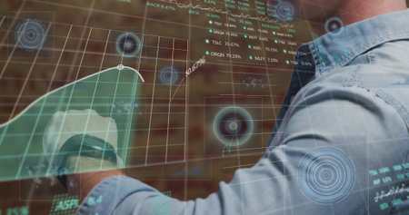 Image of stock market and data processing over caucasian man checking smartwatch. Global technology...