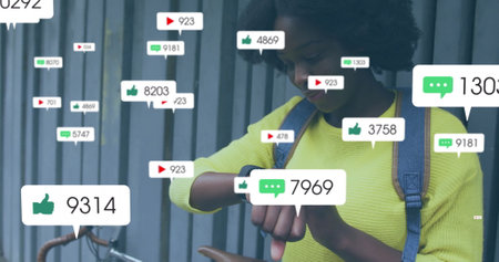 Image of media icons over african american woman using smartwatch. Technology, social media and...