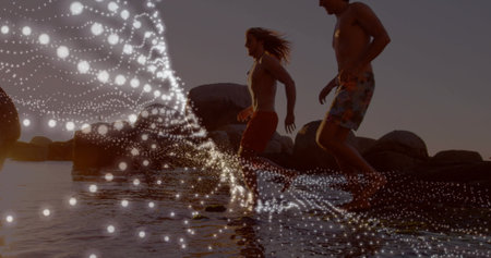 Running on beach, people with glowing particles image over water. Exercise, fitness, summer,...