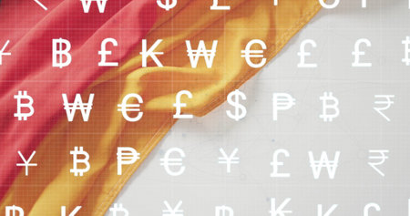 Currency symbols image over red and yellow fabric background. Finance, money, wealth, economy, monetary, investmentの写真素材