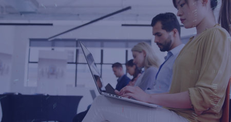 Image of professionals in office using laptops during business meeting, focusing on work. coworkers, teamwork, collaboration, brainstorming, corporate, technologyの写真素材