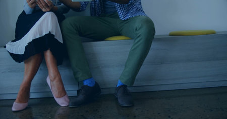 Couple sitting together on bench, holding hands and enjoying conversation indoors. relationship,...