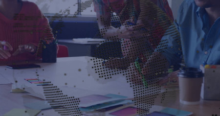 Collaborating on project, team brainstorming ideas with digital overlay at office desk. Teamwork,...