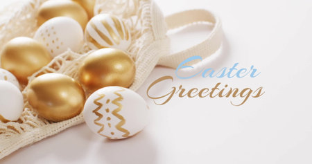 Image of easter greetings text over gold and white eggs on white background. Easter, tradition and...