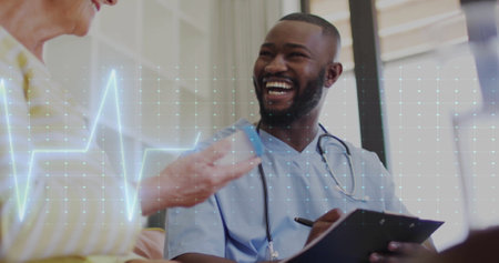 Image of cardiograph over senior caucasian woman talking with african american male nurse. Medicine, retirement and digital interface concept digitally generated image.の写真素材
