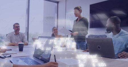 Image of financial data processing over diverse colleagues discussing work in office. Global business, finances, computing and digital interface concept digitally generated image.の写真素材