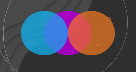 Image of vibrant circles and lines moving on black background. Colour, pattern, shape and movement...