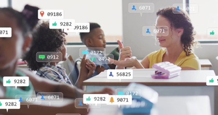 Image of media icons over diverse schoolchildren learning with female teacher. Technology, education and digital interface concept digitally generated image.の写真素材