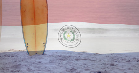 Surfboards standing on sandy beach over Paraguay flag image. ocean, coastline, waves, seashore, surfing, sportの写真素材