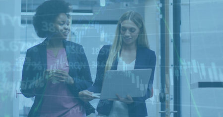 Image of financial data processing over diverse female colleagues using laptop in office. Global...