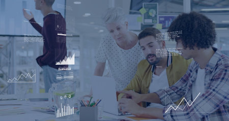 Analyzing data and graphs image over diverse team collaborating in office. analytics, teamwork,...