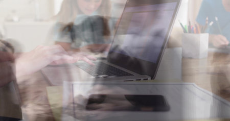 Image of people walking over caucasian businesswoman using laptop in office. Global business, finances, communication and digital interface concept digitally generated image.の写真素材