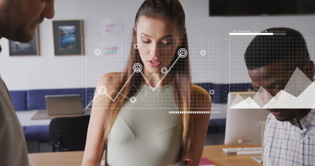 Image of data processing and diagrams over diverse business people at meeting. Technology, business and digital interface concept digitally generated image.の写真素材