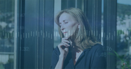 Image of financial data processing over caucasian businesswoman in office. Global finance, business,...