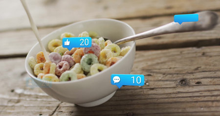 Pouring milk into cereal bowl, social media notifications image over wooden table. Breakfast,...