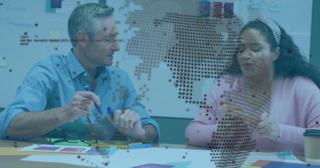 Image of data processing and globe over diverse colleagues talking in office. Business and digital...