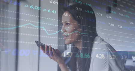 Image of diagrams and data processing over biracial businesswoman talking on smartphone. Global...