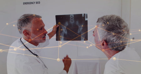 Image of network of connections over caucasian male doctors reading x-ray scan. Global medicine,...
