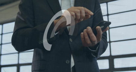 Image of financial data processing over biracial businessman using smartphone in office. Global...