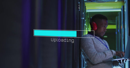 Image of loading bar over african american man working in server room. Global technology and digital...