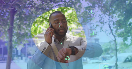 Image of eco icons and data processing over afrcian american man using smartphone. Global...