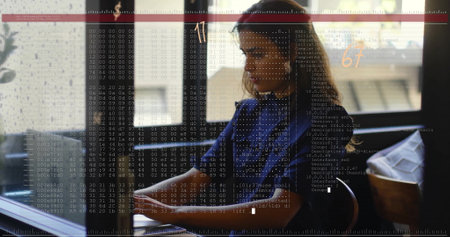 Image of financial data processing over caucasian businesswoman using laptop. Global finance,...