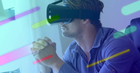 Image of colourful shapes over caucasian man using vr headset. Technology, social media and digital...