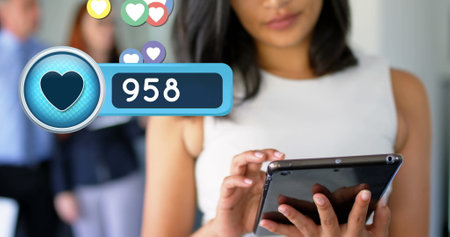 Woman using tablet, receiving likes and notifications, engaging with social media. Technology,...