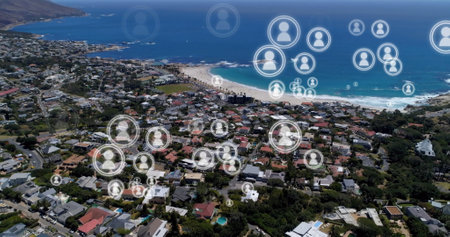 Aerial view of coastal town with digital social network icons overlaying community. networking,...