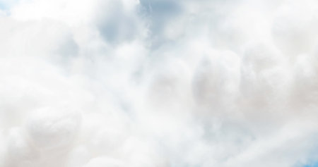 Fluffy white clouds floating gently across bright blue sky on sunny day. Cloudscape, atmosphere, weather, nature, outdoorsの写真素材