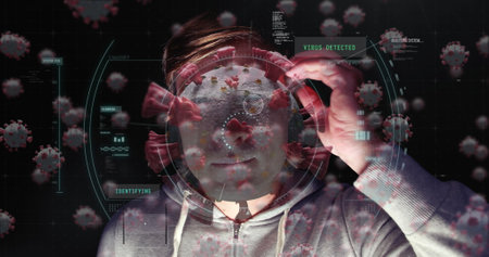 Analyzing virus data on digital interface, man in hoodie with focused expression. Cybersecurity,...
