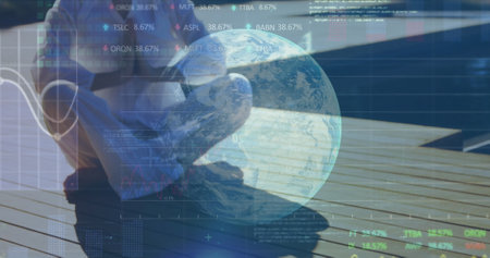 Person sitting on deck using laptop, analyzing global financial data trends. Technology, finance,...