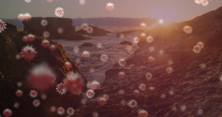 Sunset over rocky coastline with floating particles in foreground. Nature, landscape, ocean, sky, dramaticの写真素材