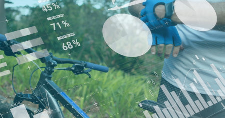 Checking smartwatch data, cyclist outdoors wearing blue gloves and digital interface. Cycling, technology, sports, fitness, activity, trackingの写真素材
