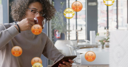 Drinking coffee, young person using smartphone in cafe with virus emojis floating. Technology, pandemic, hygiene, beverage, health, publicの写真素材