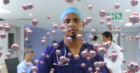 Healthcare worker in hospital surrounded by virus illustrations, showing resilience. Pandemic,...