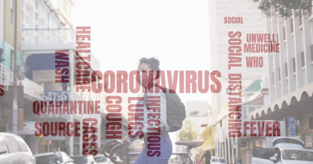 Image of coronavirus text over woman wearing face mask walking in the street with bike. protection and social distancing against virus during pandemic digital compositeの写真素材