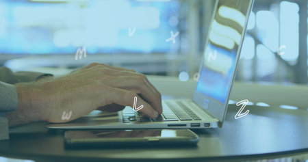 Image of numbers and letters moving over man typing on laptop. digital interface global connection and communication concept digitally generated image.の写真素材