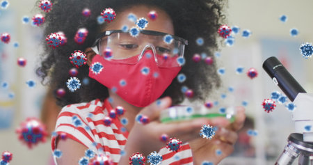 Image of cornoavirus cells and schoolgirl in science class wearing face mask. healthcare and protection during coronavirus covid 19 pandemic, digitally generated image.の写真素材