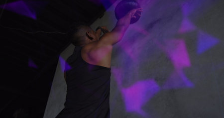 Image of colourful shapes over man exercising with a ball. Digital interface global sport and...