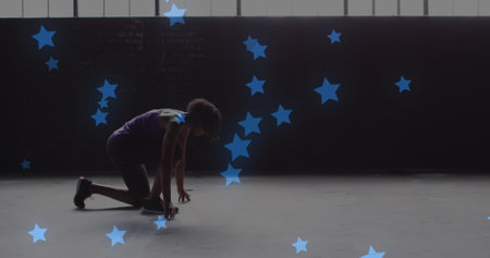 Multiple blue stars floating against african american woman in start position ready to run. sports and fitness conceptの写真素材
