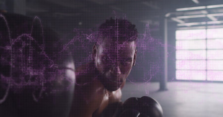 Digital composite image of purple digital waves against male boxer punching a punching bag. sports and fitness conceptの写真素材
