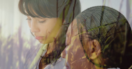 Image of grass on a windy field over nurse supporting patient at the hospital. Global medicine...