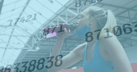 Image of numbers changing over woman in face mask drinking water taking break in exercising. global...