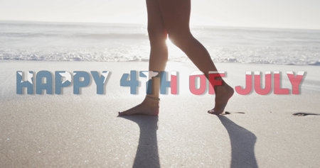 Image of happy 4th of july text with american flag pattern over woman walking on beach. usa, patriotism and democracy concept digitally generated image.の写真素材