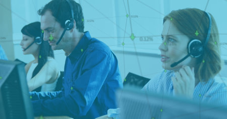 Customer service team using headsets and computers, collaborating in modern office. Call center,...