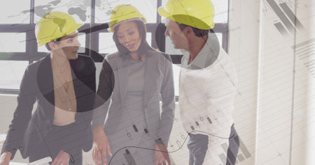 Business professionals wearing hard hats discussing project plans in modern office. Construction,...