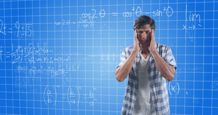 Confused man holding head, standing in front of complex math equations. Confusion, problem-solving, mathematics, brainstorming, frustration, calculationsの写真素材