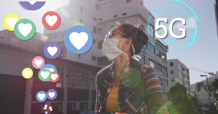 Asian woman wearing mask outdoors surrounded by digital 5G icons and graphics. Technology, innovation, connectivity, future, communication, smartphoneの写真素材
